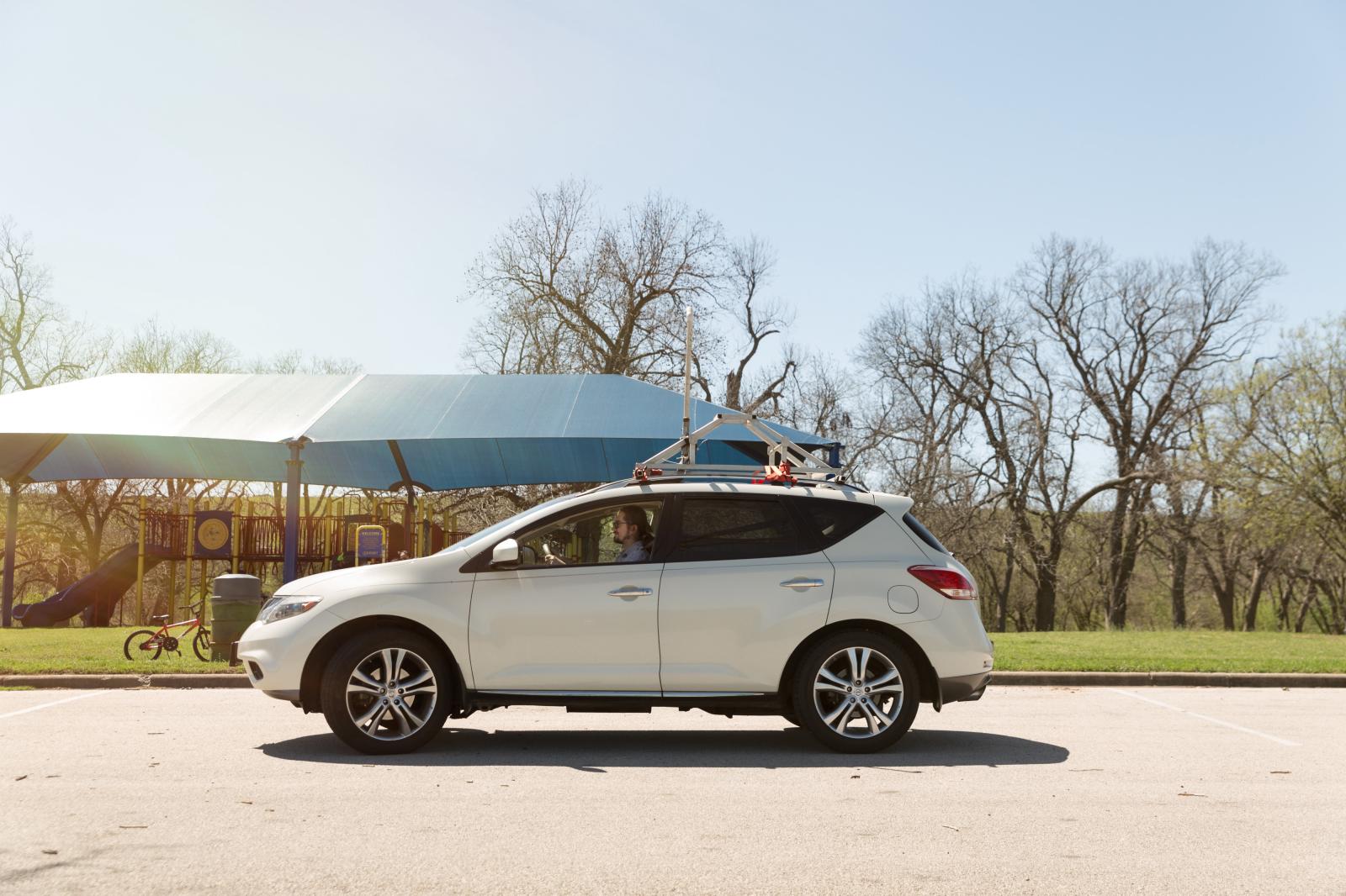 UT Austin researcher drives an SUV equipped with a state-of-the-art air sampling device through a park in eastern Travis County.