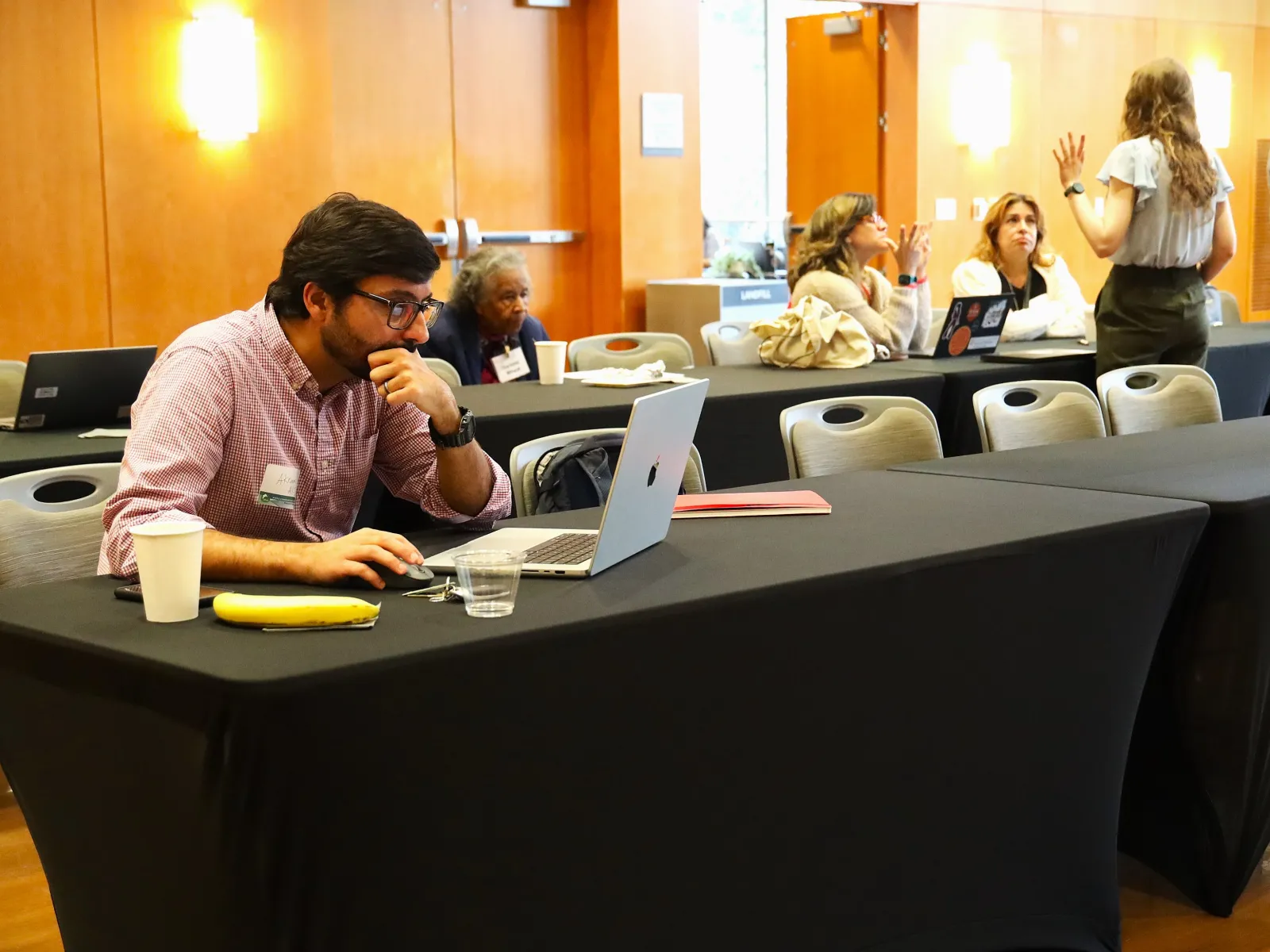 Flash-funding award recipient Akram Al-Turk, a research associate at the Moritz Center for Societal Impact at the Steve Hicks School of Social Work, works on his grant proposal at the WCWH Symposium, February 7.