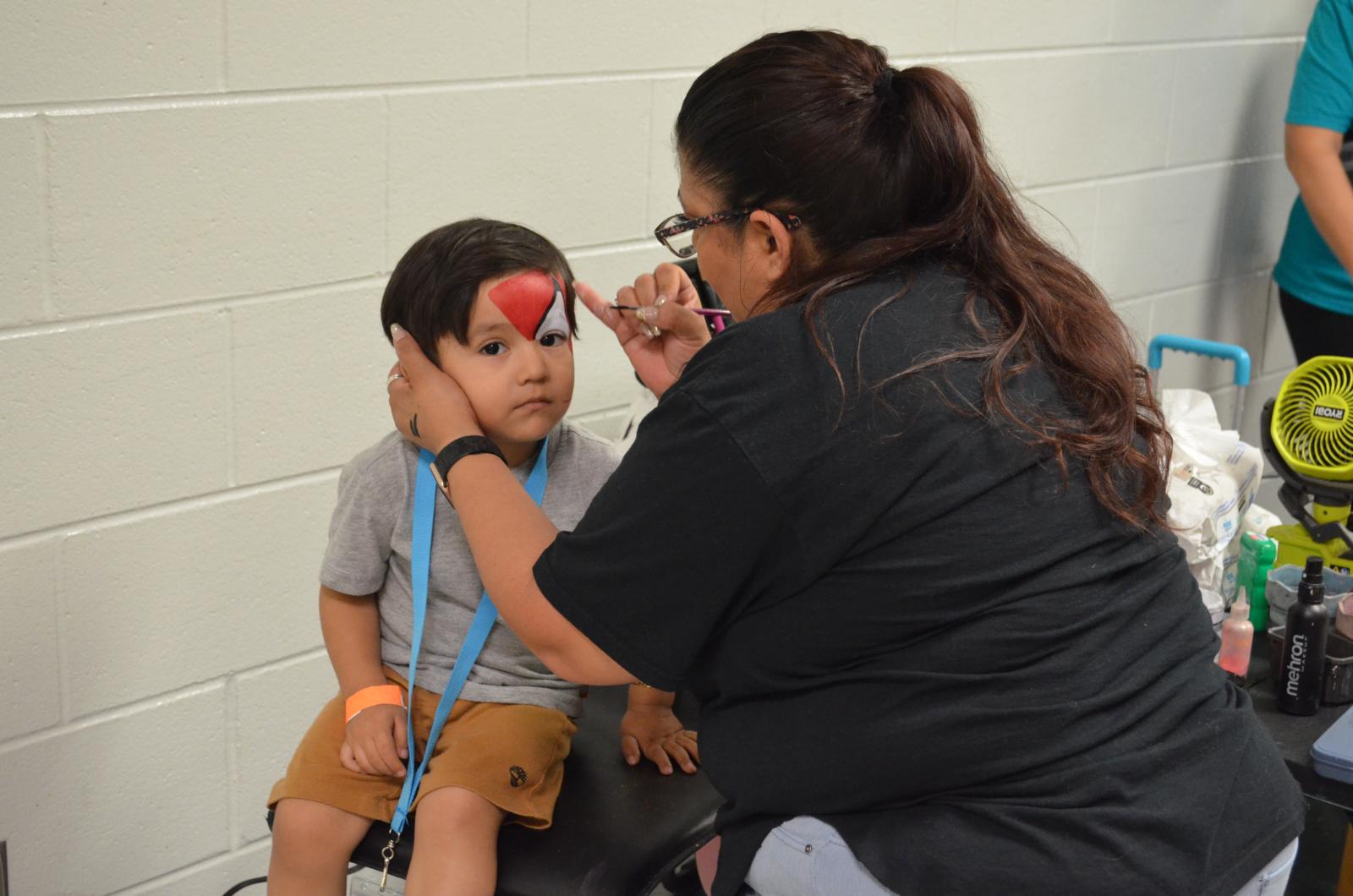 A child gets his face painted at Community Resource Day; April 2024
