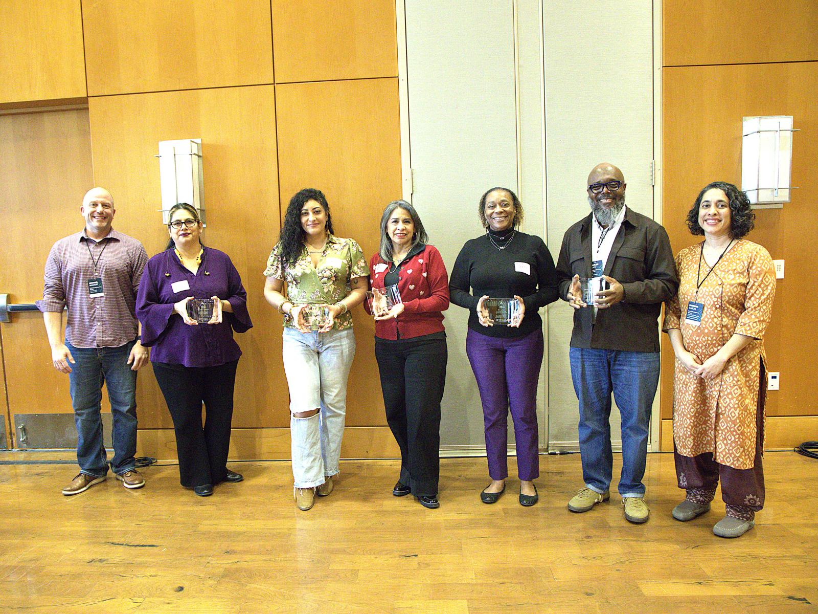 Left to right: Whole Communities–Whole Health (WCWH) chair Mike Mackert, Barbara Soriano, Ellena Gonzales, Rebecca Gomez, Mia Greer, Dr. Charles Moody and WCWH Community Engagement Manager Shirene Garcia pose at the 2026 WCWH Symposium. (Not pictured: Maggie Jaime and Carol Lilly.)