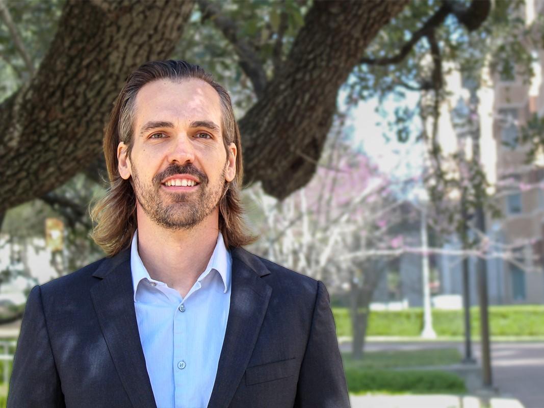 Smiling portrait of Brad Knox standing outside on campus