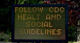 A digital traffic sign (with typo) alerts people to find and refer to CDC guidelines during the COVID-19 pandemic.