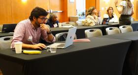 Flash-funding award recipient Akram Al-Turk, a research associate at the Moritz Center for Societal Impact at the Steve Hicks School of Social Work, works on his grant proposal at the WCWH Symposium, February 7.