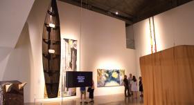 A wide shot of the main room of the Visual Arts Center from opening night of the "How to Grow the Cowpea" exhibition. September 4, 2026; UT Austin campus