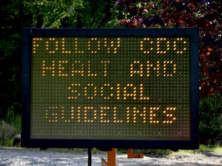 A digital traffic sign (with typo) alerts people to find and refer to CDC guidelines during the COVID-19 pandemic.