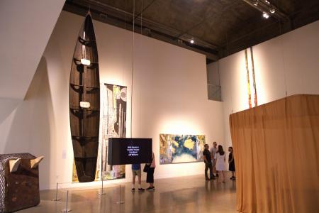 A wide shot of the main room of the Visual Arts Center from opening night of the "How to Grow the Cowpea" exhibition. September 4, 2026; UT Austin campus
