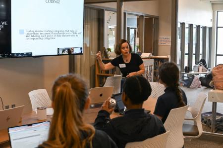 Professor Katie Dawson, director of Drama for Schools, leads students in a data analysis exercise at Ann Richards School for Young Women Leaders in Austin. Photo by Jessica Alexander.